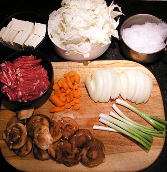 It's easy to make Sukiyaki at home. Just some slicing and dicing and ten minutes of simmering and you will have a delicious Japanese hot pot brimming with beef, rice noodles, tofu and vegetables, in a sweet soy broth l Panning The Globe Recipe