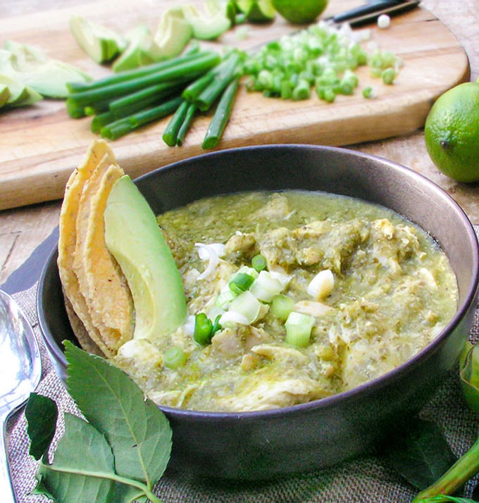 Guatemalan Green Chicken Stew recipe - Tender chicken simmered in a tomatillo cilantro sauce, thickened with toasted ground pumpkin seeds and sesame seeds. A delicious festive healthy soup/stew that also low fat, gluten free and paleo friendly.