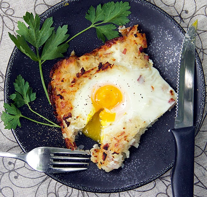 Rösti is a Swiss shredded potato casserole with ham, onions and cheese melted in, and soft-cooked eggs baked on top. It's the perfect brunch recipe. Plus, you can do most of the prep ahead of time.