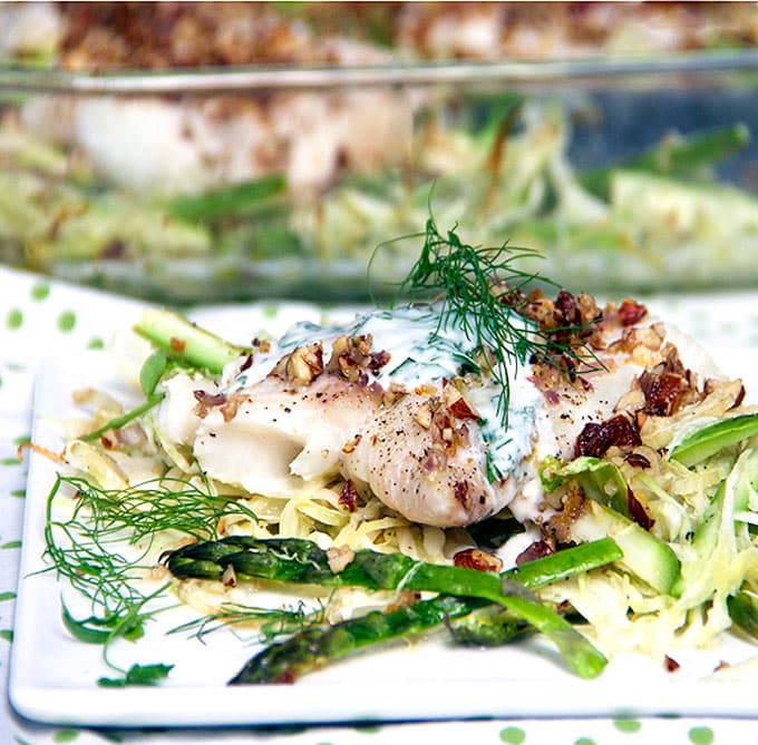 Fresh haddock fillets are baked an a bed of shredded vegetables and topped with delicious lemon almond gremolata l www.panningtheglobe.com 