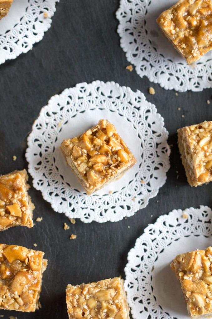 Sesame Cashew bars with caramel and shortbread on lace doilies