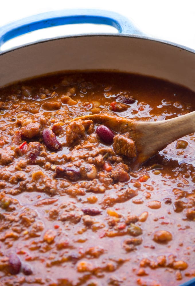 Close up of Eddie's award winning chili in a pot with a wooden spoon