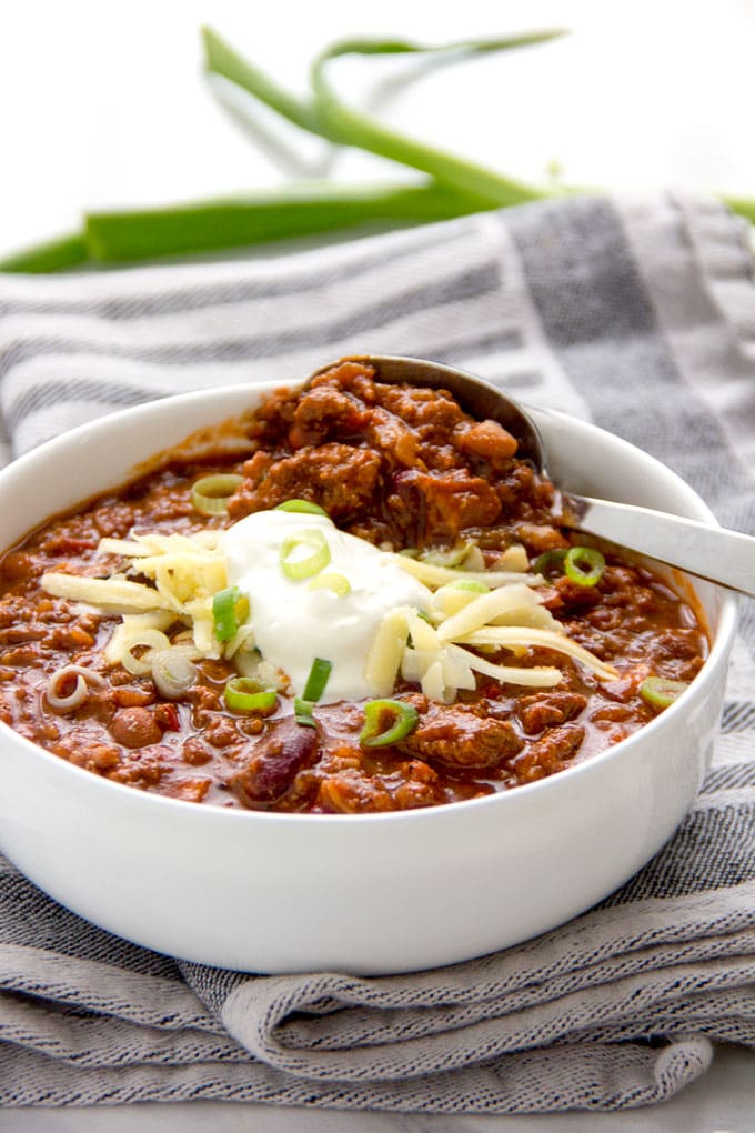 a bowl of award winning chili con carne with toppings