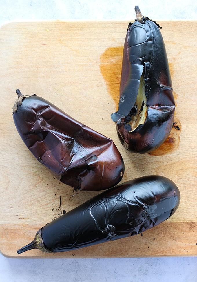 burnt eggplants on a cutting board, ready to make baba ganoush