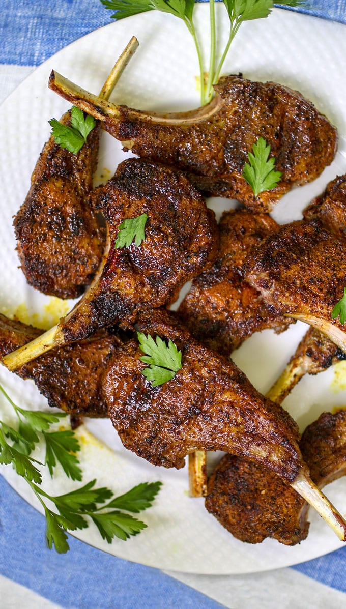 A plate of grilled lamb chops with parsley garnish