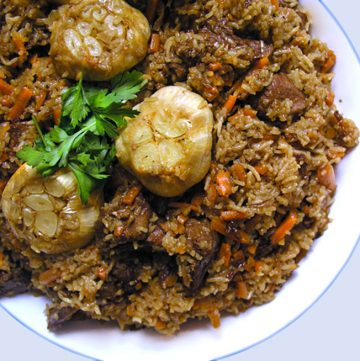 Plov, a popular dish in Uzbekistan, is like risotto meets lamb stew - a delicious festive dish of tender lamb, rice, carrots, onions and wonderful spices.
