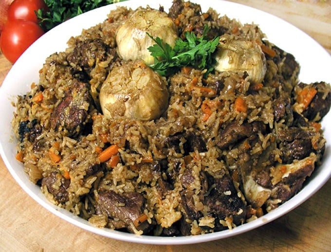 Plov, a popular dish in Uzbekistan, is like risotto meets lamb stew - a delicious festive dish of tender lamb, rice, carrots, onions and wonderful spices.