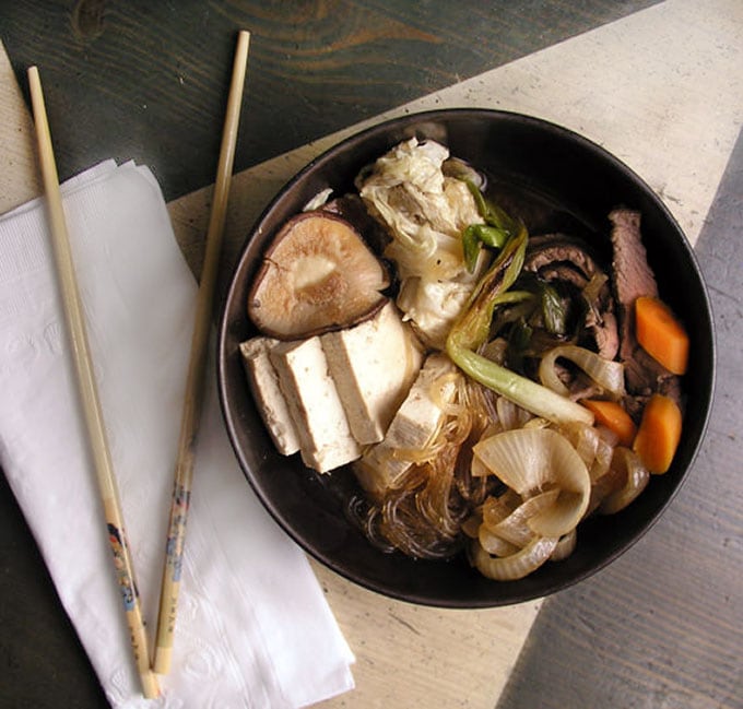 It's easy to make Sukiyaki at home. Just some slicing and dicing and ten minutes of simmering and you will have a delicious Japanese hot pot brimming with beef, rice noodles, tofu and vegetables, in a sweet soy broth l Panning The Globe Recipe