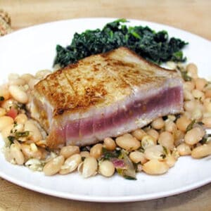 Seared tuna steak on a bed of white beans