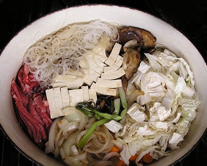 It's easy to make Sukiyaki at home. Just some slicing and dicing and ten minutes of simmering and you will have a delicious Japanese hot pot brimming with beef, rice noodles, tofu and vegetables, in a sweet soy broth l Panning The Globe Recipe