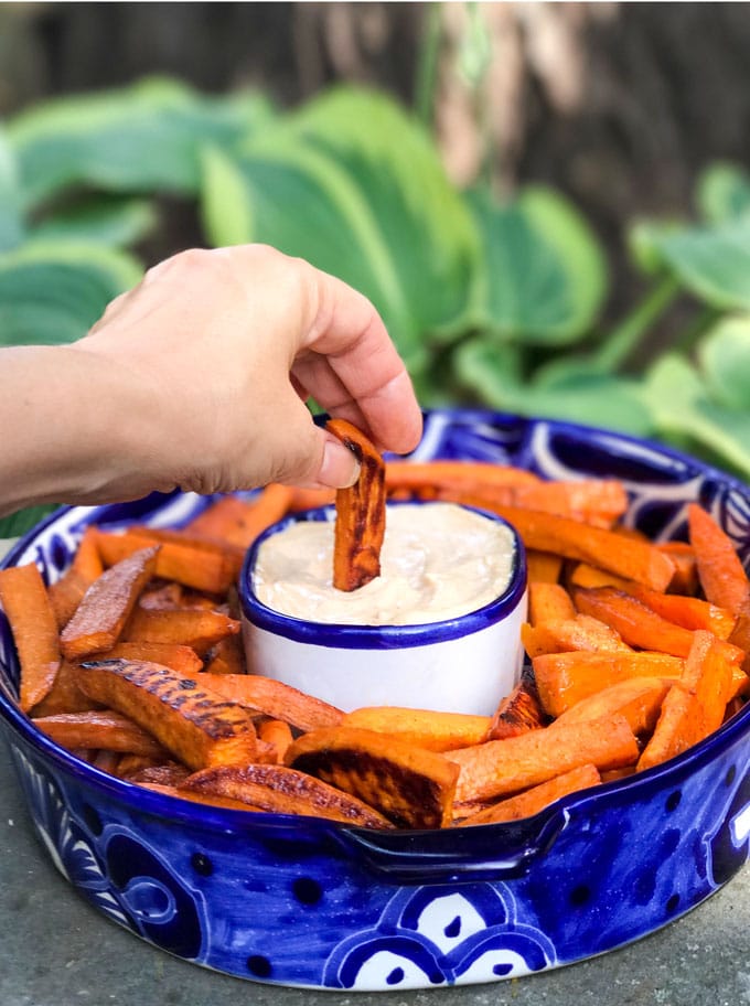 Sweet and spicy baked sweet potato wedges with chipotle aioli dipping sauce! An addictively delicious healthy appetizer recipe, side dish or game day treat.