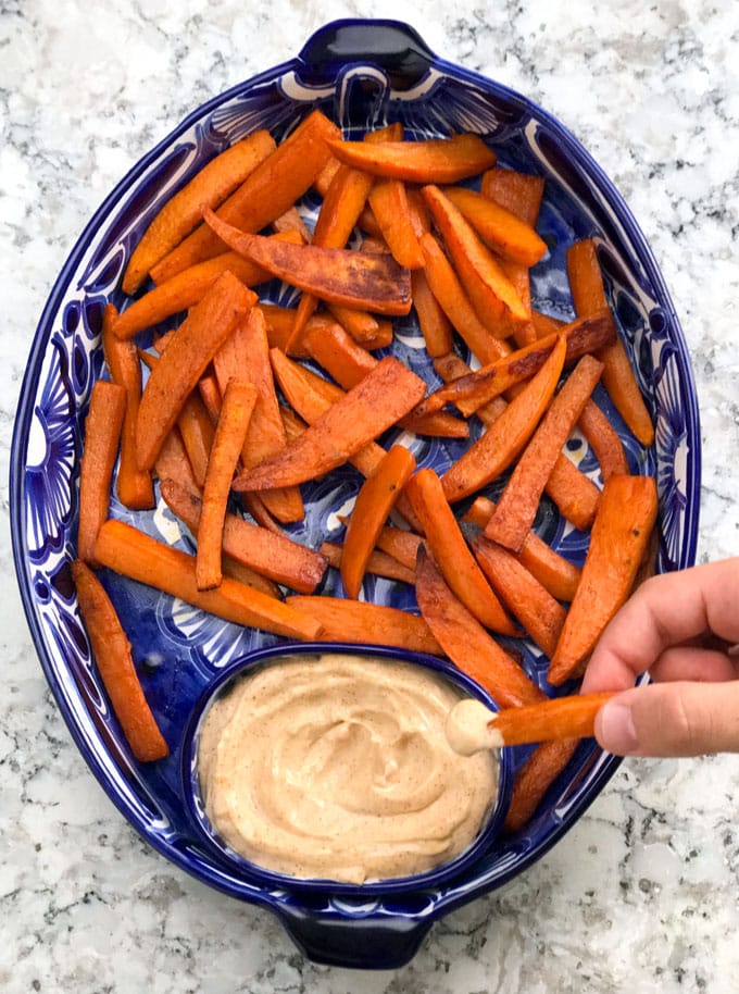 Sweet and spicy baked sweet potato wedges with chipotle aioli dipping sauce! An addictively delicious healthy appetizer recipe, side dish or game day treat.