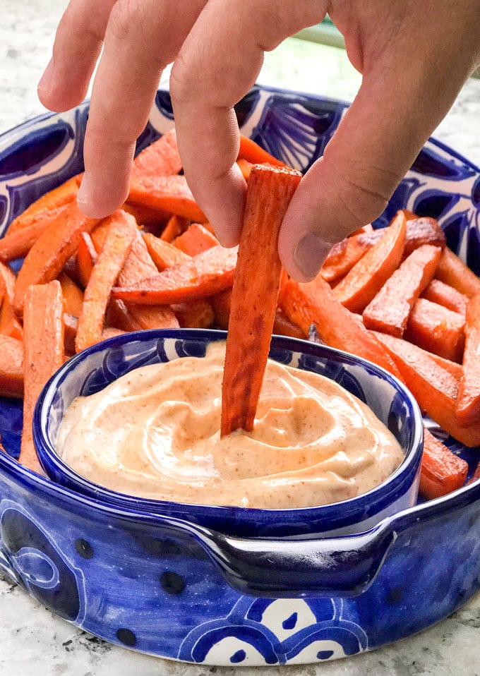 Sweet and spicy baked sweet potato wedges with chipotle aioli dipping sauce! An addictively delicious healthy appetizer recipe, side dish or game day treat.