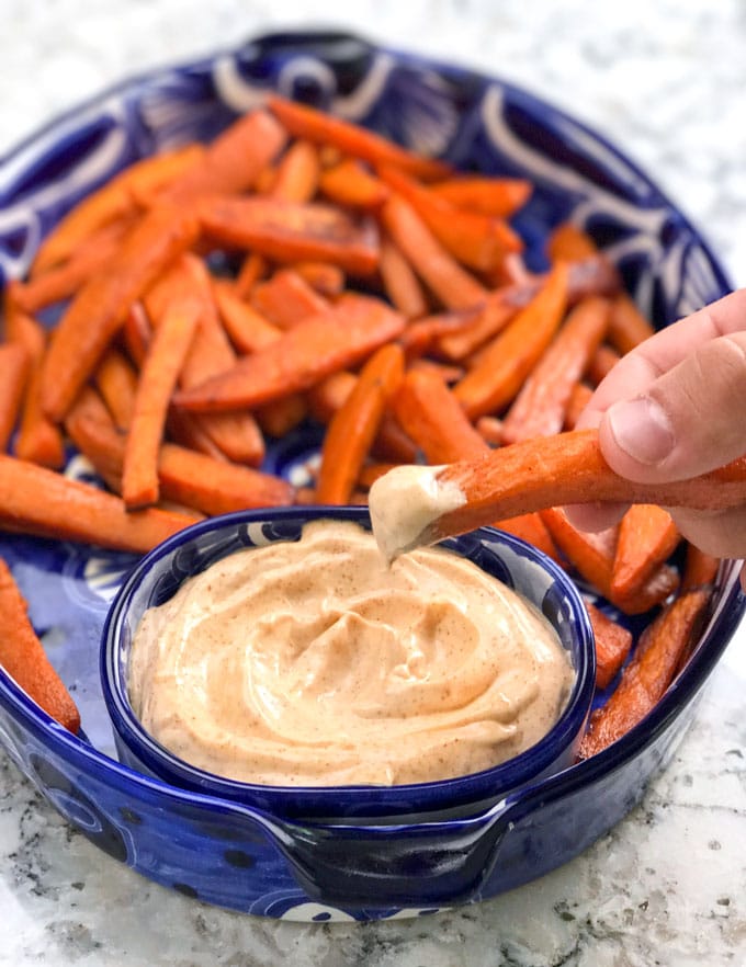 Sweet and spicy baked sweet potato wedges with chipotle aioli dipping sauce! An addictively delicious healthy appetizer recipe, side dish or game day treat.