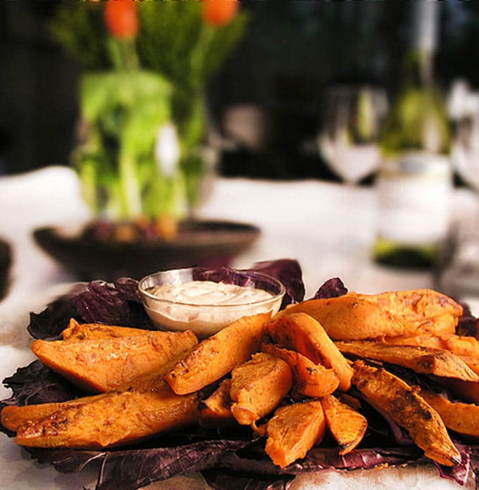 Sweet and spicy oven-baked sweet potato wedges with chipotle aioli dipping sauce! An addictively delicious healthy appetizer or game day treat.