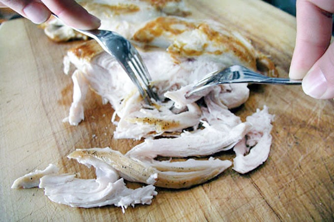 demonstration of how to shred a chicken breast using two forks