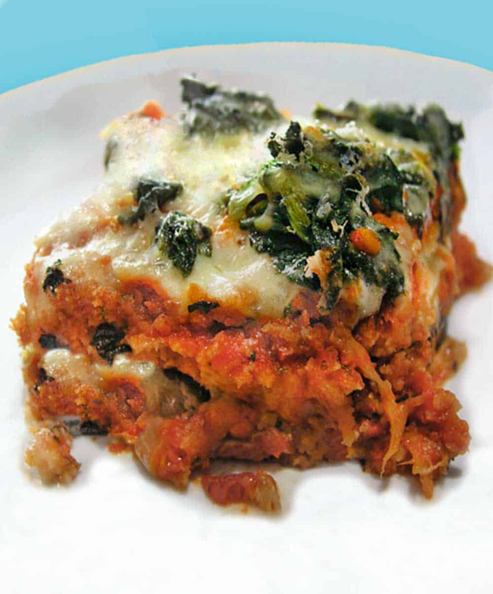 a slice of no-fry eggplant parmigiana, topped spinach and melted cheese