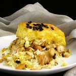 Persian Layered Chicken and Rice with Yogurt is a wonderful dish with layers of tender chicken, caramelized onions and saffron rice cooked in a casserole. The casserole is flipped over so the bottom layer, with its beautiful golden crust, becomes the top. It's served with garlicky yogurt sauce on the side.