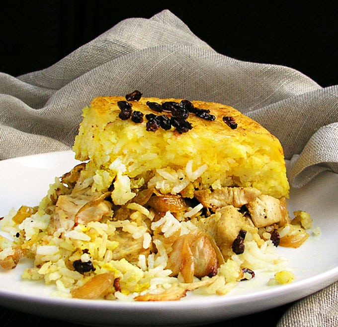 Persian Layered Chicken and Rice with Yogurt is a wonderful dish with layers of tender chicken, caramelized onions and saffron rice cooked in a casserole. The casserole is flipped over so the bottom layer, with its beautiful golden crust, becomes the top. It's served with garlicky yogurt sauce on the side.