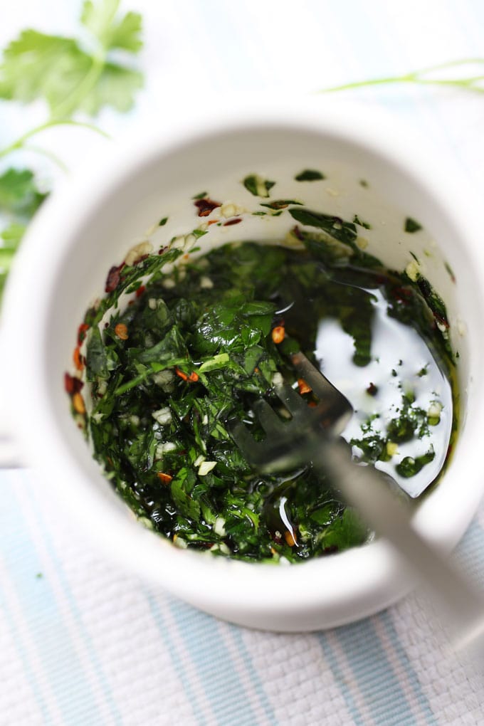 parsley garlic dressing in a cup with a fork