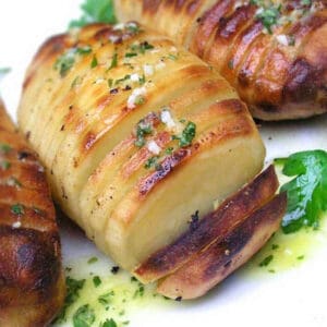 hasselback potatoes with lemon dijon vinaigrette drizzled on top.