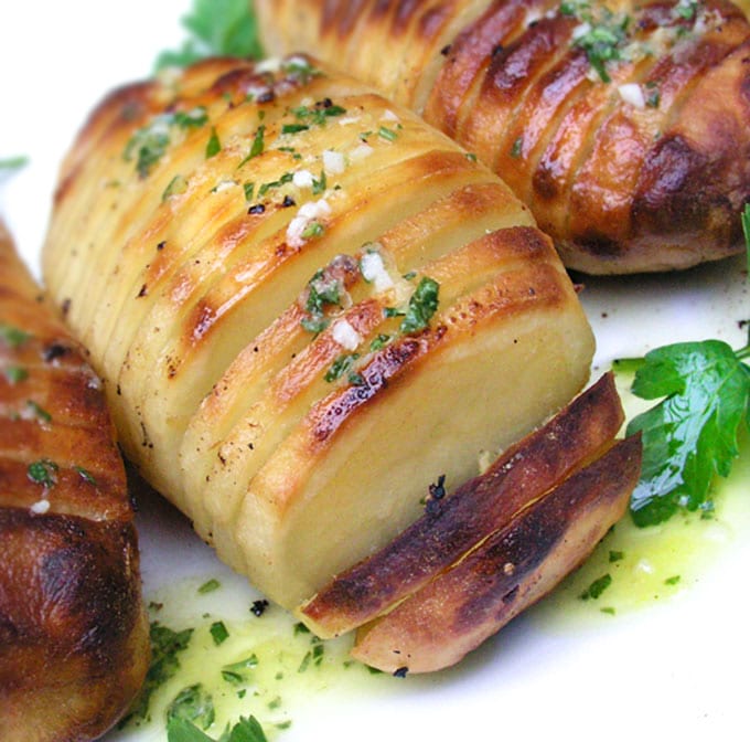 Swedish Hasselback Potatoes with lemon garlic dijon vinaigrette baked in. Learn how to transform an ordinary potato into something spectacular | Panning The Globe