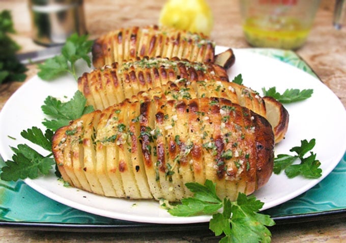 Swedish Hasselback Potatoes with lemon garlic dijon vinaigrette baked in. Learn how to transform an ordinary potato into something spectacular | Panning The Globe