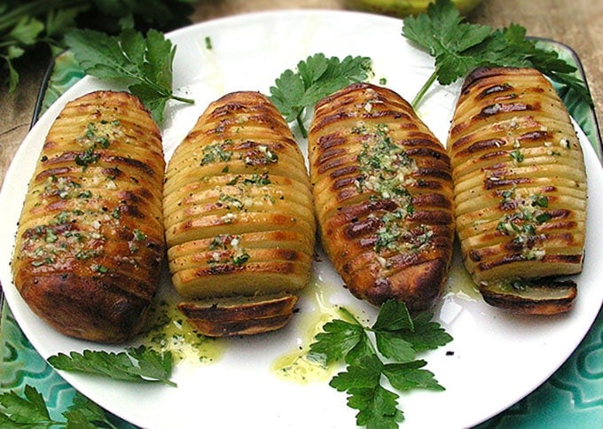 Swedish Hasselback Potatoes with lemon garlic dijon vinaigrette baked in. Learn how to transform an ordinary potato into something spectacular | Panning The Globe