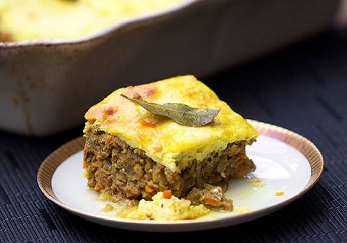 A slice of bobotie on a white plate