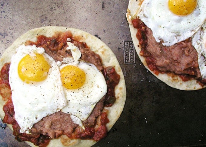 salsa, fried eggs and refried beans on two flour tortillas: how to make huevos rancheros.