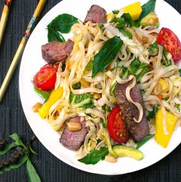White plate with Thai steak and noodles salad