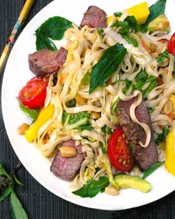 White plate with Thai steak and noodles salad