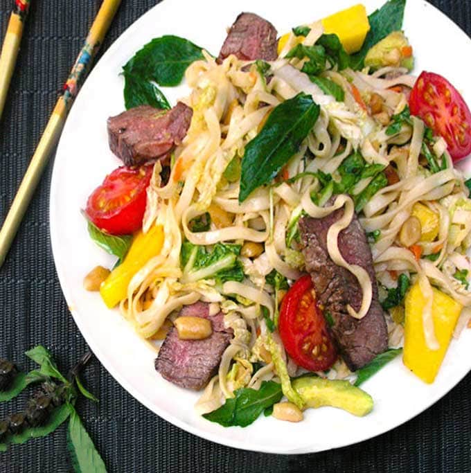 White plate with Thai steak and noodles salad