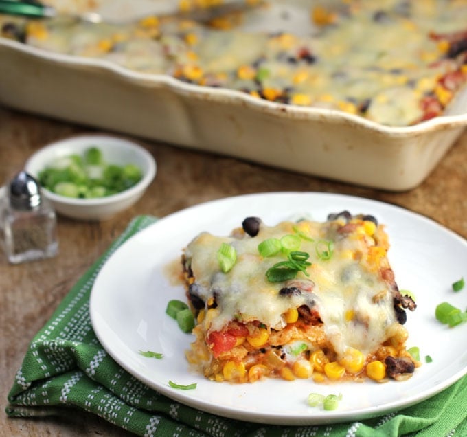 Square of Mexican Tortilla Casserole on a plate topped with scallions