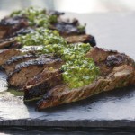 Sliced Skirt Steak topped with vibrant green Chimichurri sauce