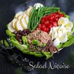 French salad nicoise with tuna, potatoes, green beans, eggs, olives, tomatoes and anchovies.