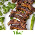 Pinterest pin: A rack of grilled ribs cut off the bone, on a white platter with cilantro