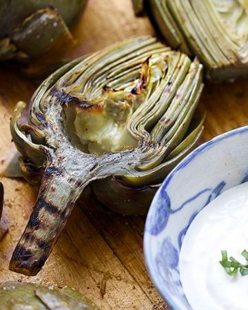 Grilled Artichokes are a fabulous appetizer for summer entertaining! You can do all the prep ahead of time. Just pop them on the grill right before serving. Grilling intensifies their wonderful flavor and the lemony aioli is the perfect companion.