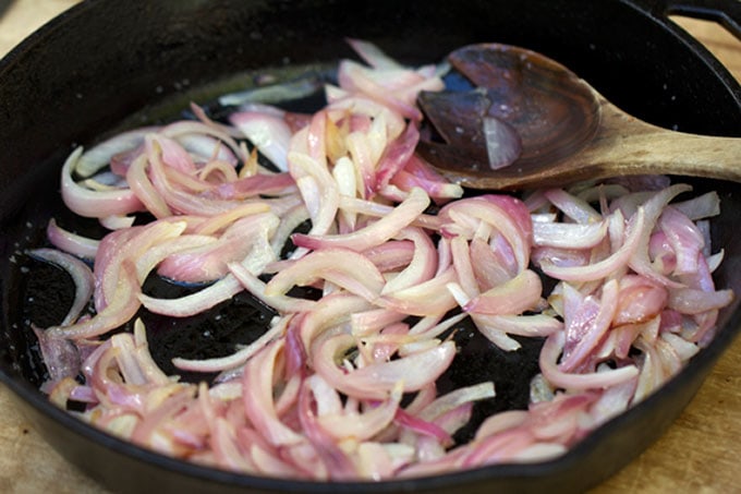 Sautéed red onions in a skillet