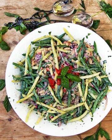 This three bean salad recipe is packed with delicious nutritious vegetables, fresh basil, and a and a tasty lemony yogurt dressing - panningtheglobe.com