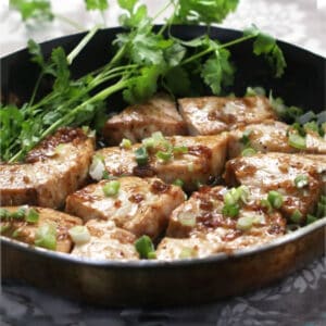 caramelized fish fillets in a cast iron skillet.