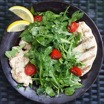 Chicken paillard is an Italian classic that's perfect for grilling season: thinly pounded chicken marinated in lemony dressing, grilled, and topped with arugula salad and more lemony dressing. It's a quick ad easy recipe that's satisfying, healthy, and delicious.