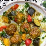 a bowl of Indian spiced lamb meatball stew with colorful ratatouille