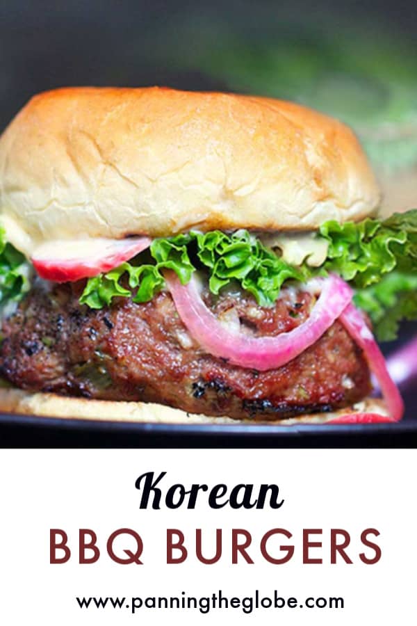 Korean bbq burger in a bun with lettuce and pickled red onions
