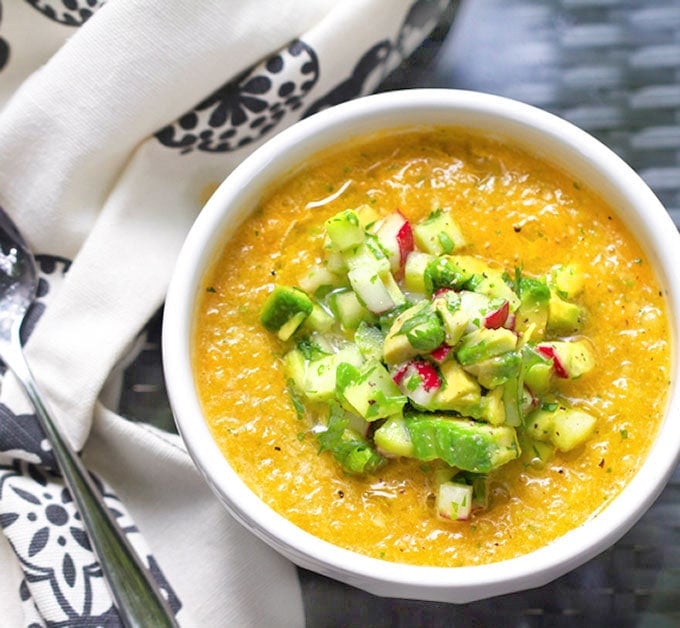 This Gazpacho can be made with yellow or red tomatoes. Serve it icy cold with the delicious topping of chopped cucumbers, radishes and avocados. The quintessential summer soup recipe l www.panningtheglobe.com