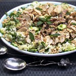 asian cabbage salad with grilled chicken, cucumbers and mint on a large round platter