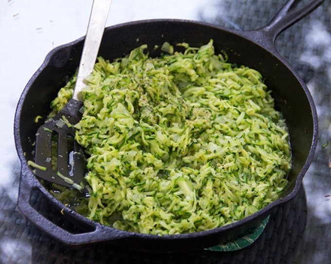 Sauteed shredded zucchini in a cast iron skillet