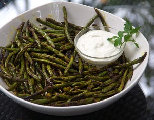 Spicy, flavorful, grilled green beans are an addictive healthy appetizer. Fresh green beans are tossed with homemade Indonesian satay spice mix and grilled. Serve with lemony, garlicky aioli to dip.