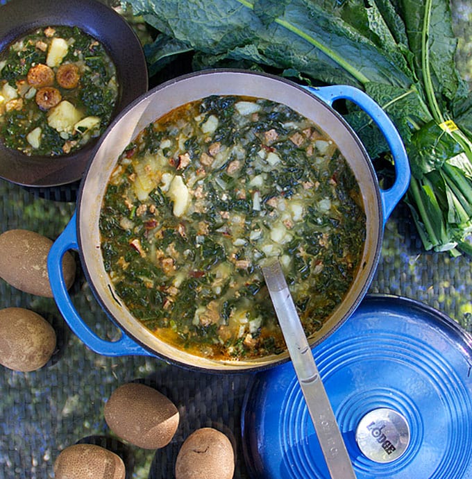 a blue Dutch oven filled with Portuguese Sausage Kale Potato Soup