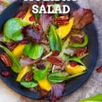 Holiday Salad Pinterest Image, a mixed green salad with orange segments and toasted pecans.